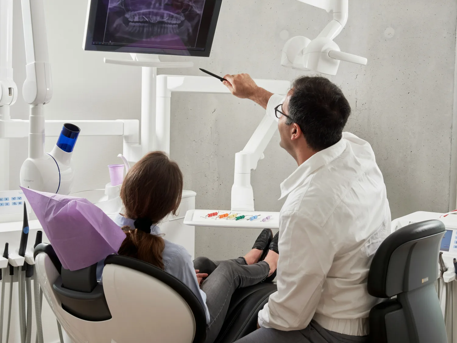 Odontólogo revisando una radiografía con su paciente
